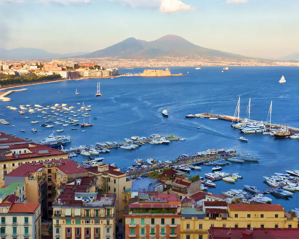 A view of Naples from above, with Mount Vesuvius in the distance
