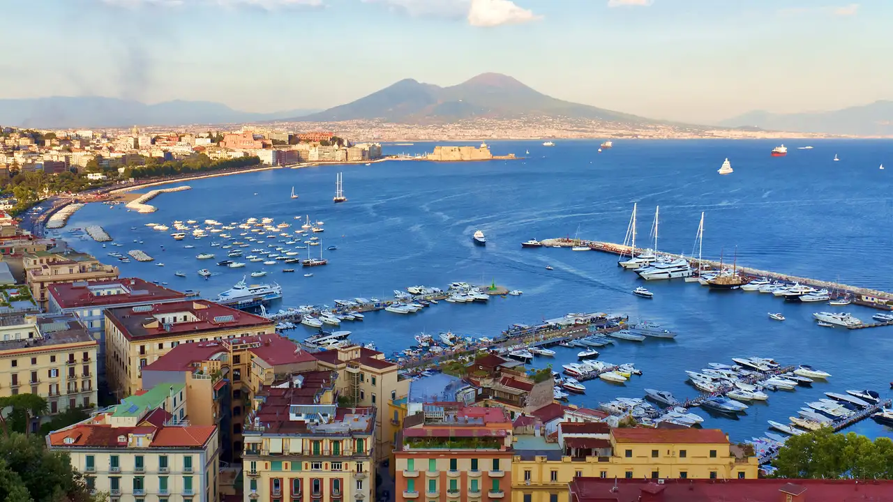 A view of Naples from above, with Mount Vesuvius in the distance