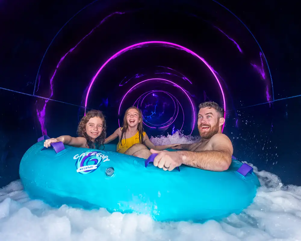 A Family going down a water slide onboard a Royal Caribbean ship