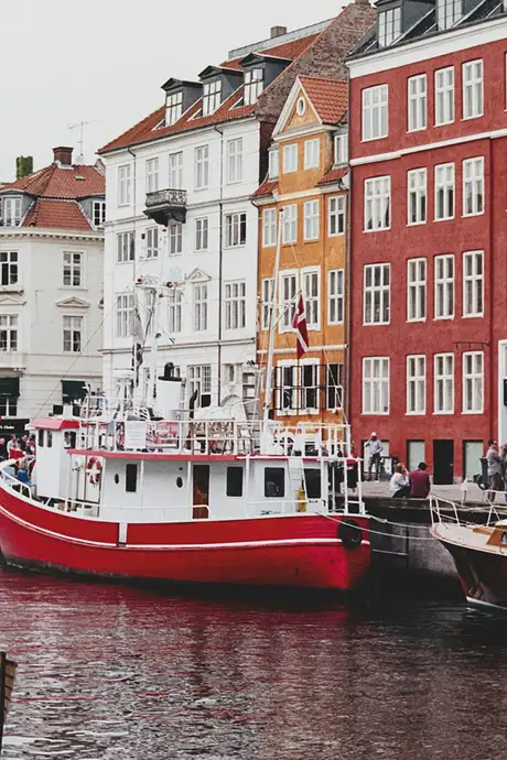 The boats parked along a river in Copenhagen