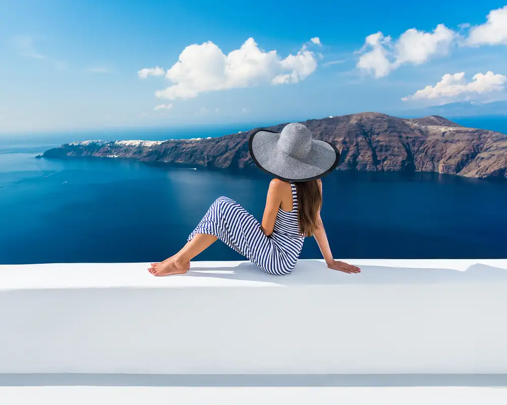 A Woman sitting on a balcony in Greece