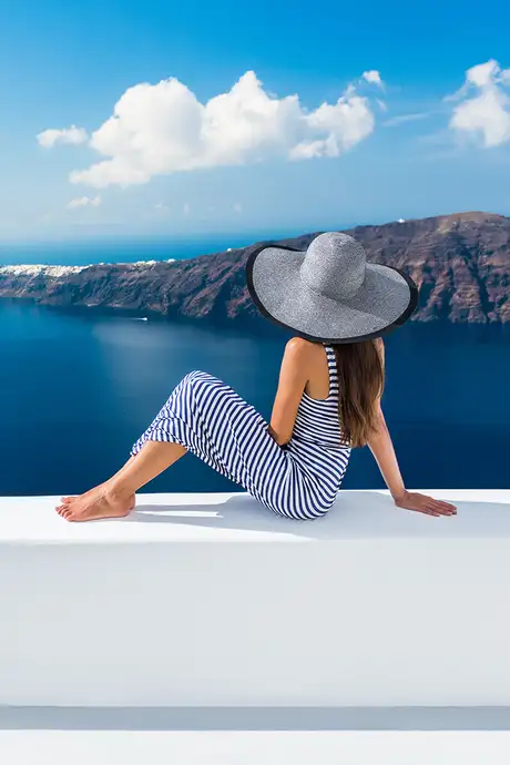 A Woman sitting on a balcony in Greece