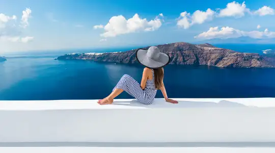 A Woman sitting on a balcony in Greece