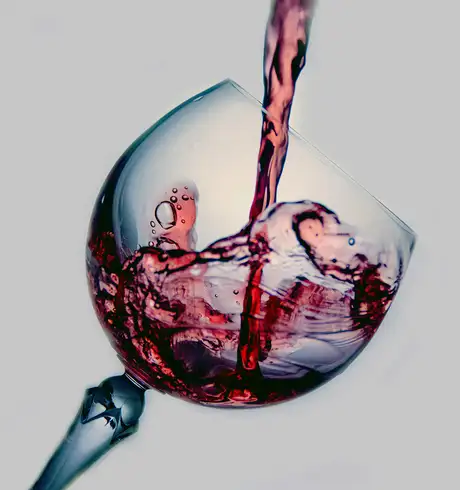 A glass of wine being poured