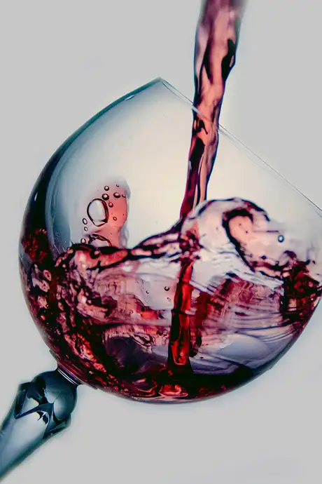 A glass of wine being poured