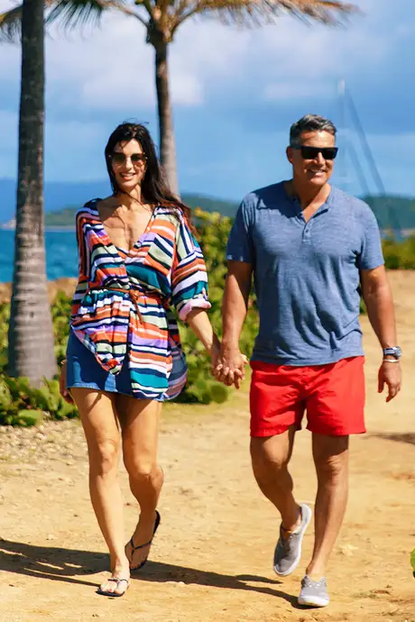A couple walking down a beach path on an Azamara Holiday