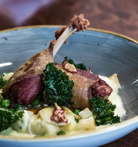 A Dish featuring mashed potatoes, spinach and duck