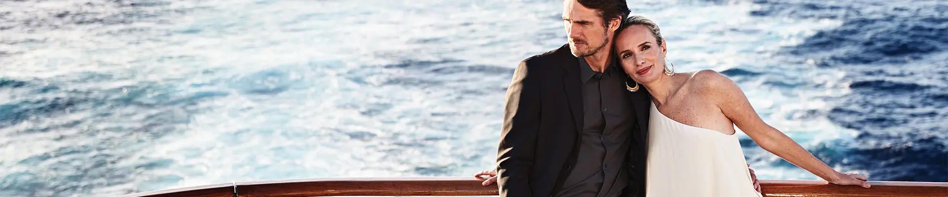A Couple leaning on a railing aboard a Princess Cruise ship