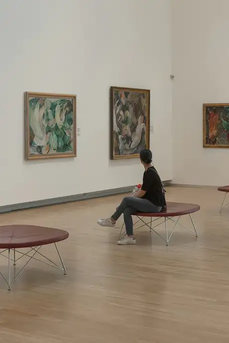 A person looking at an art exhibit in the Nationalmuseet or The National Museum of Denmark in Copenhagen