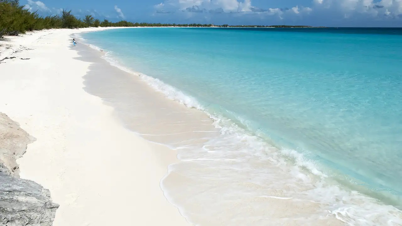 A Sunny beach with white sand and crystal clear water on Half Moon Cay