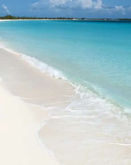 A Sunny beach with white sand and crystal clear water on Half Moon Cay