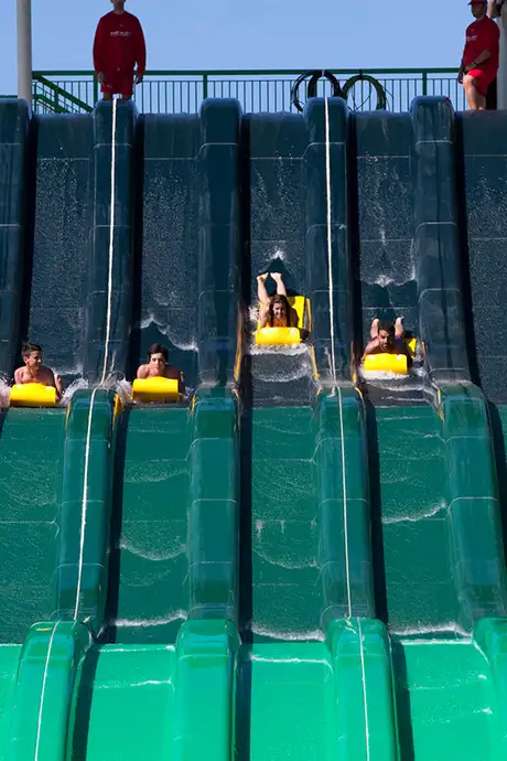 A Group of people riding a waterslide in the Caribe Aquatic Park in Port Aventura World