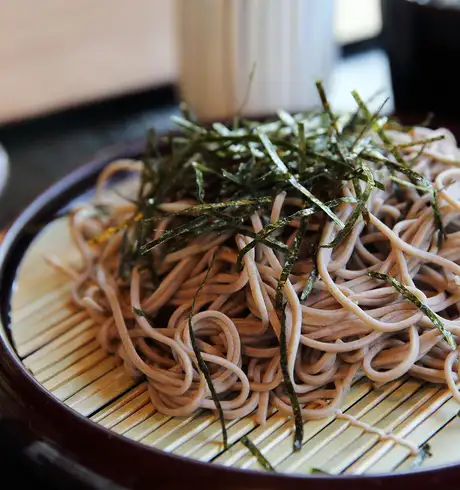 A noodle dish topped with shredded Seaweed