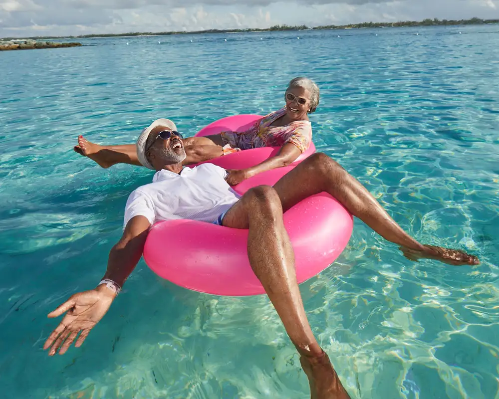 A Couple floating in the ocean on a Carnival Cruise