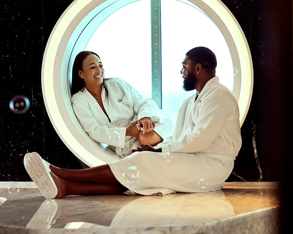 A Couple relaxing in a spa aboard a Virgin Voyages Ship