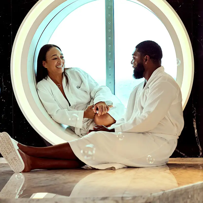 A Couple relaxing in a spa aboard a Virgin Voyages Ship