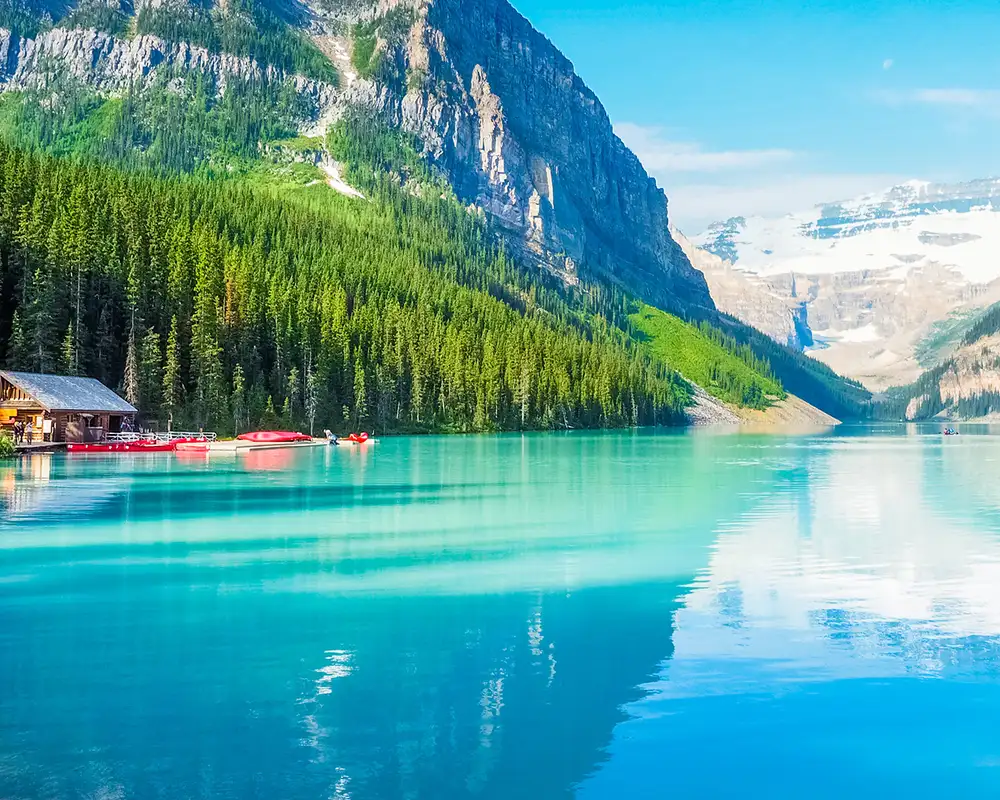 A landscape view of Banff National park showing a building on the shore of a lake