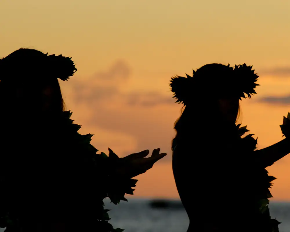 Two Luau Dancers dancing at sunset