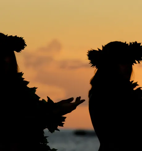 Two Luau Dancers dancing at sunset