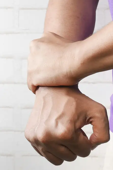 A person holding pressure on their wrist
