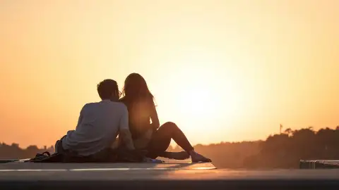 A Couple sitting watching the sunset