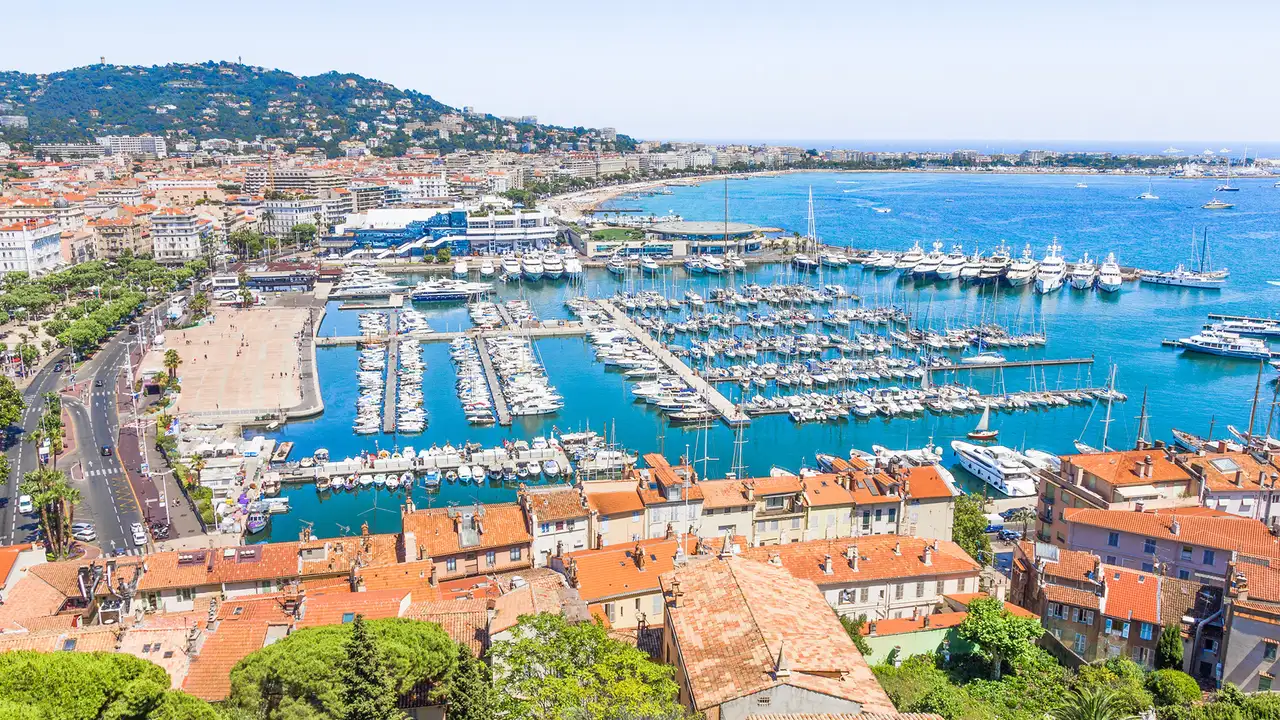 An image of Cannes in the south of France, Showing a marina with lots of docked boats