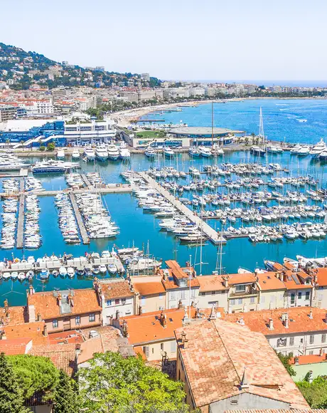 An image of Cannes in the south of France, Showing a marina with lots of docked boats
