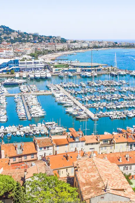 An image of Cannes in the south of France, Showing a marina with lots of docked boats
