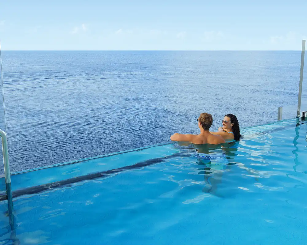 A couple relaxing in an NCL Ship's pool