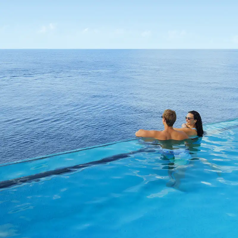 A couple relaxing in an NCL Ship's pool