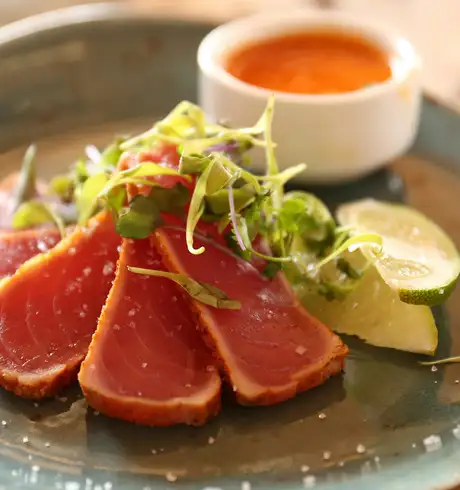 A fancy dish featuring some vegetables and tuna