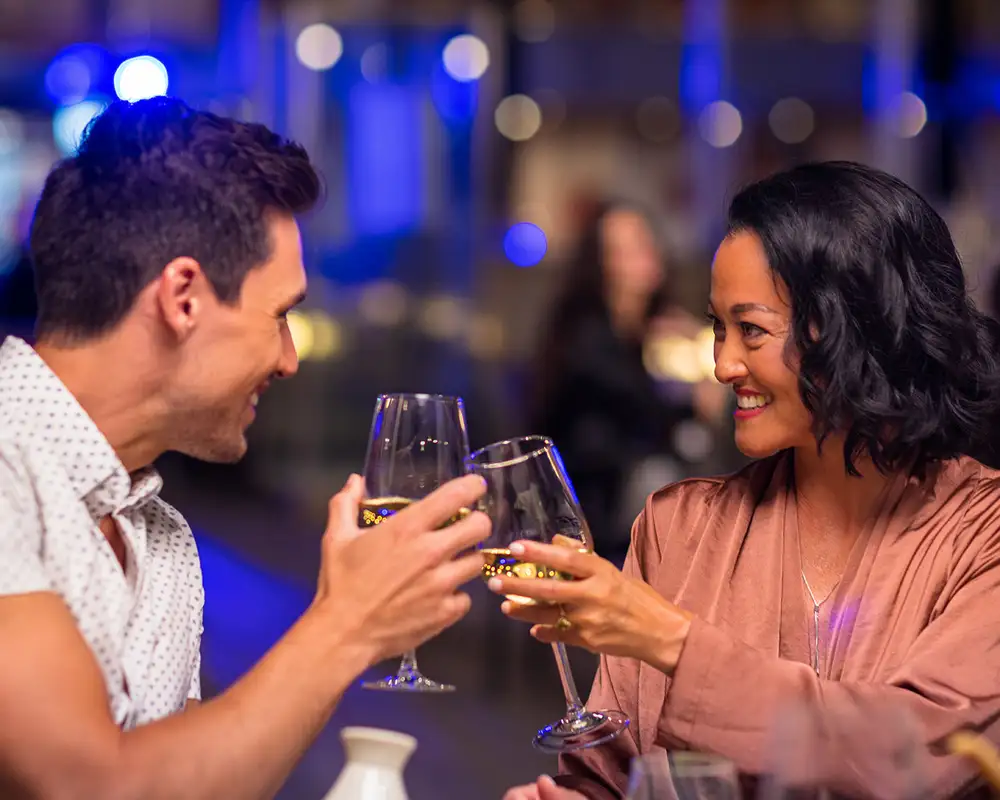 A Couple cheering drinks on a Seabourn Ship