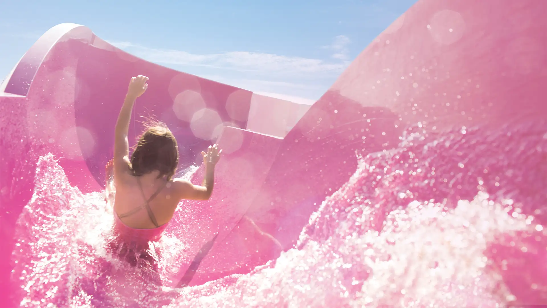 A Girl going down a water slide aboard a NCL Ship