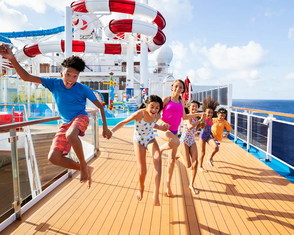 A group of Children running on the deck of a Carnival Ship