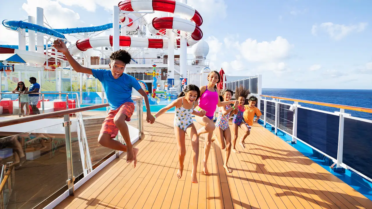 A group of Children running on the deck of a Carnival Ship