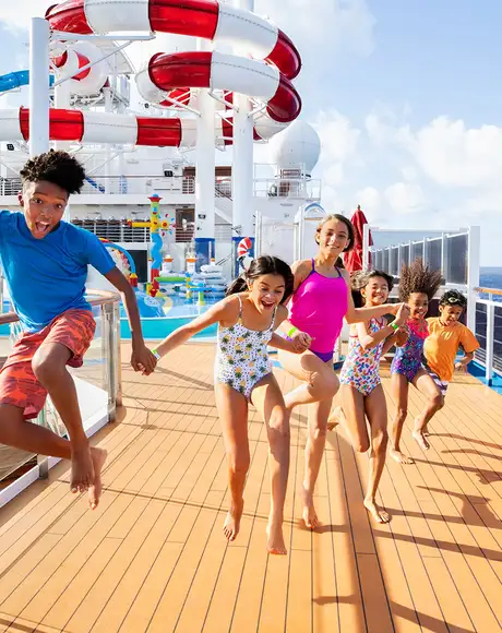 A group of Children running on the deck of a Carnival Ship
