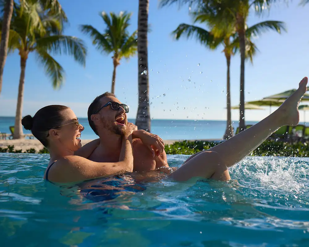 A Couple in a pool on Cococay, as part of a Celebrity Cruises Holiday