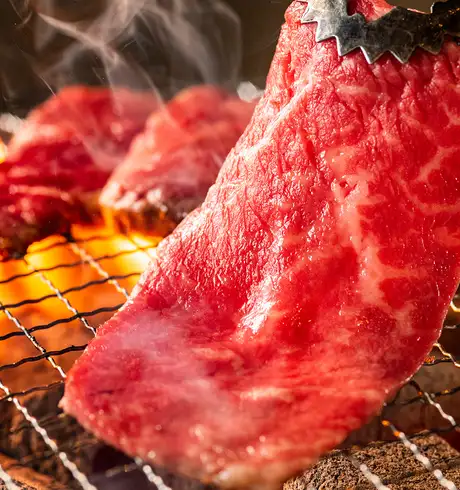 Meat being cooked on a Japanese BBQ Grill