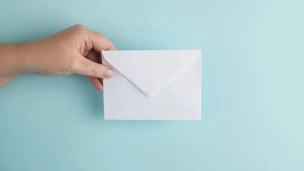 A Hand holding an Envelope