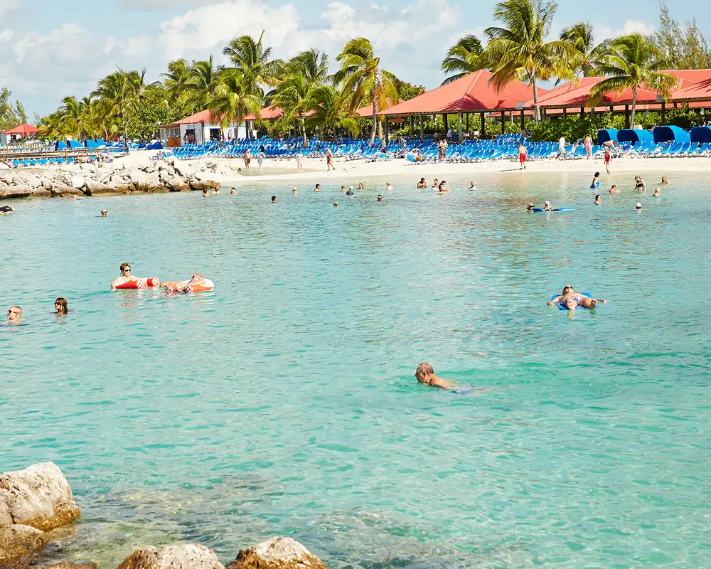 A beach and lagoon in Princess Cays full of people