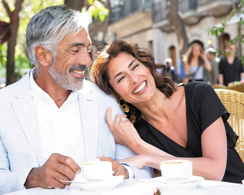 A couple on a Regent shore excursion at a cafe