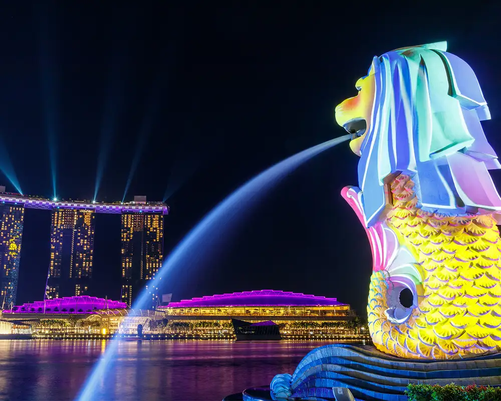 A view of Marina Bay Sands in Singapore with the Merlion Statue in frame