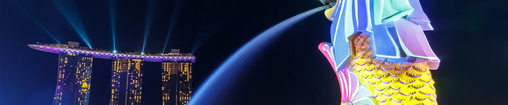 A view of Marina Bay Sands in Singapore with the Merlion Statue in frame