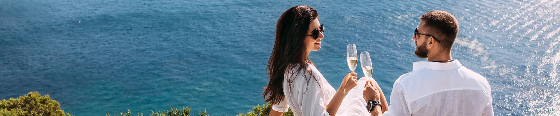 A Couple enjoying Champagne, sitting on a cliffside