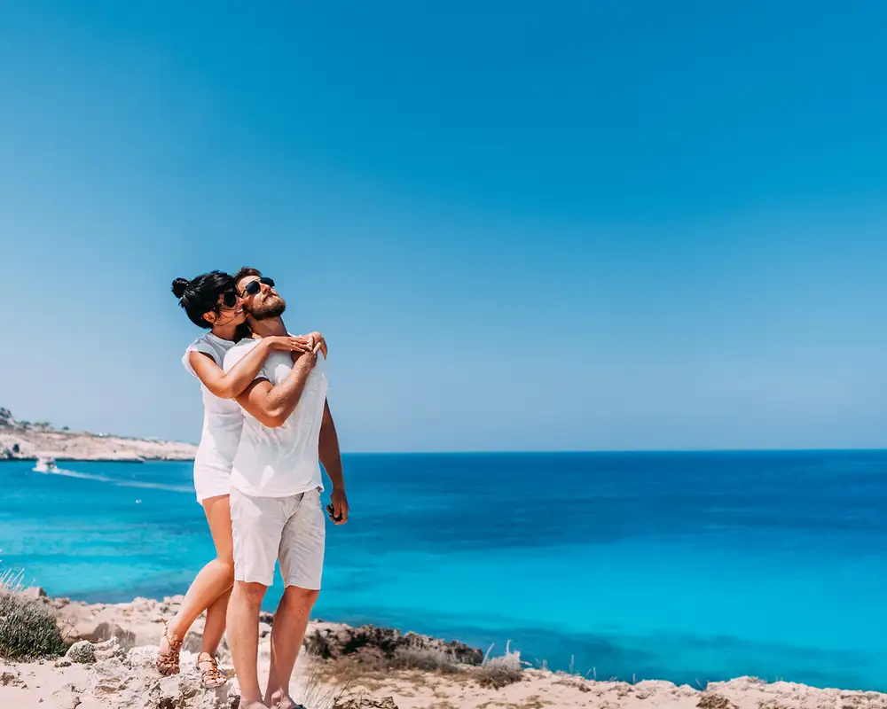 A couple standing together on a Mediterranean beach
