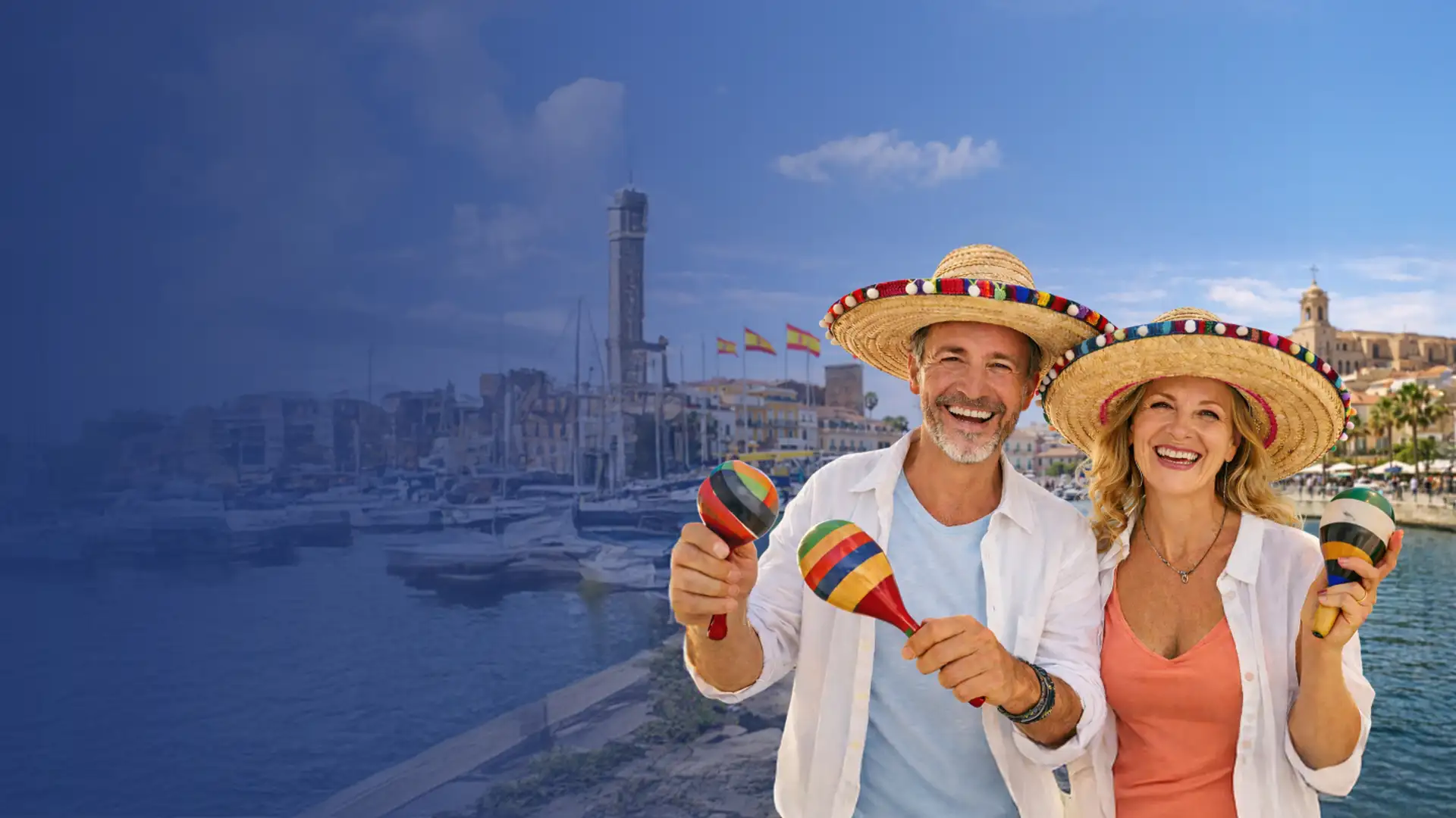 Smiling couple in sombreros holding maracas, standing by a waterfront with boats and a lighthouse in the background on a sunny day.