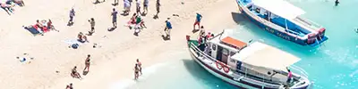A white sand beach covered in people on holiday