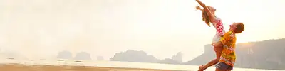 A couple standing on a sunny beach