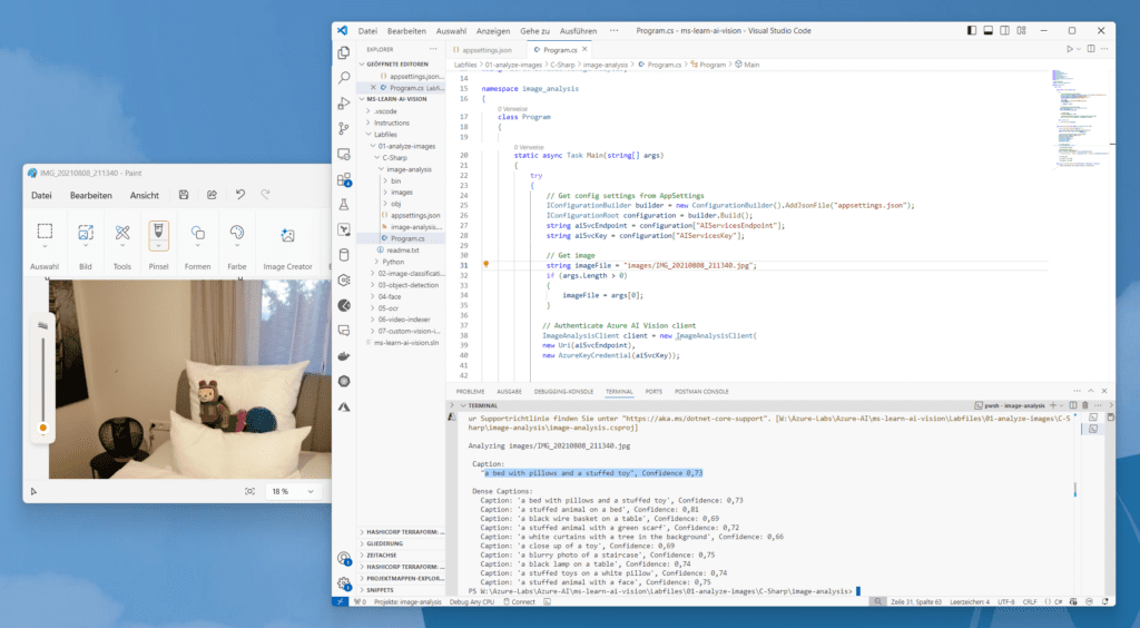 Ein Computerbildschirm zeigt eine Programmierumgebung mit mehreren geöffneten Fenstern, darunter ein Code-Editor und ein Bildbetrachter, der eine Katze auf einem Bett zeigt.