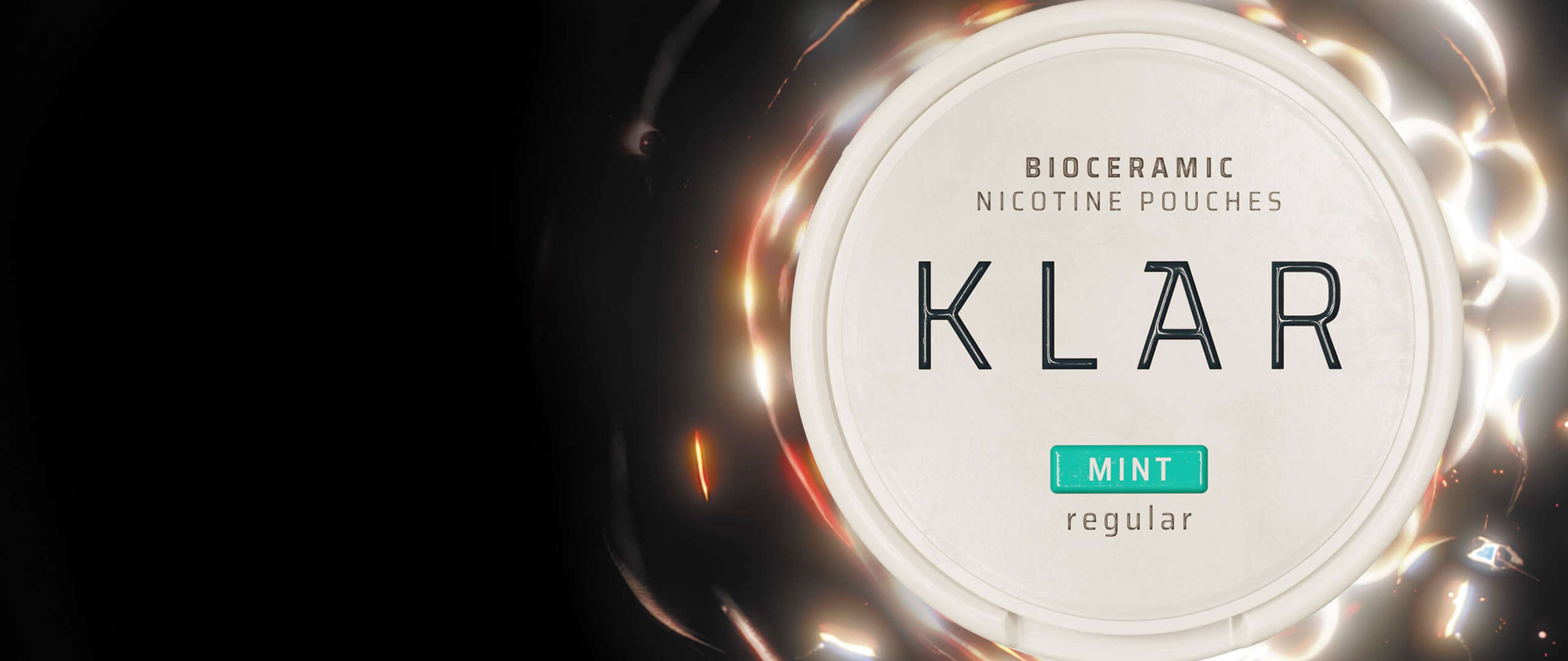 Close-up of a KLAR bioceramic nicotine pouches container labeled "Mint" and "Regular," set against a dark background with light reflections.